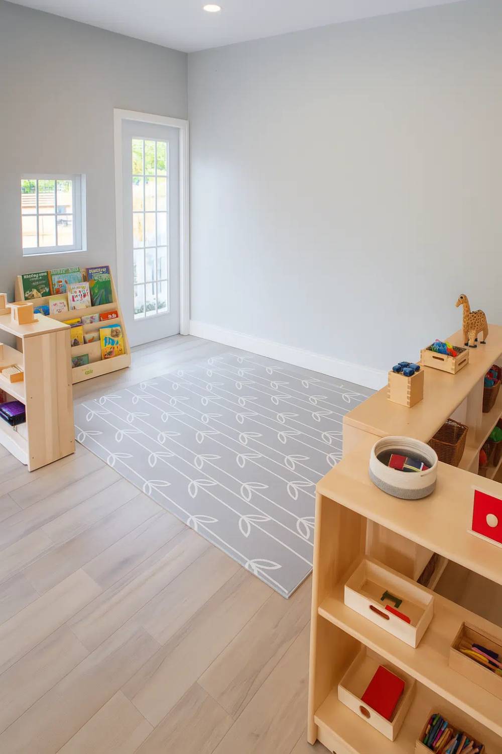 Child-sized tables and shelves with colorful hands-on materials for fine motor development, sensory play, and early academic skills.
